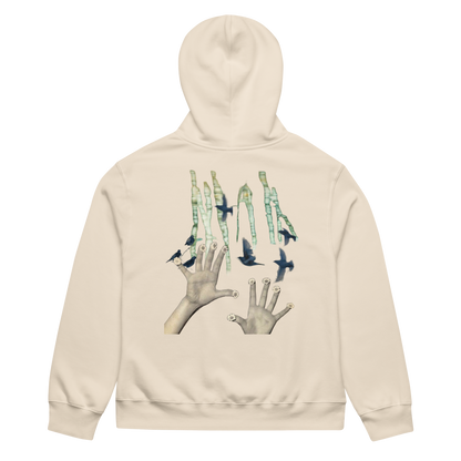Beige hoodie with a graphic design on the back featuring hands and birds on a white background