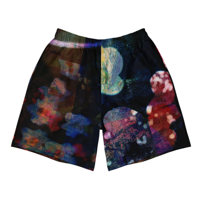 A pair of men's athletic shorts featuring an all-over abstract, colorful print with a dark base and vibrant splashes of blue, red, purple, and green, shown against a plain white background.