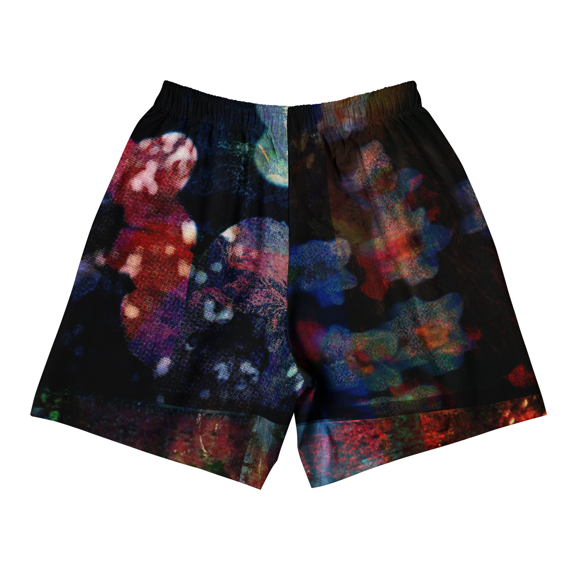 A pair of athletic shorts featuring an all-over abstract, multicolored print on a black base, shown flat against a solid white background.