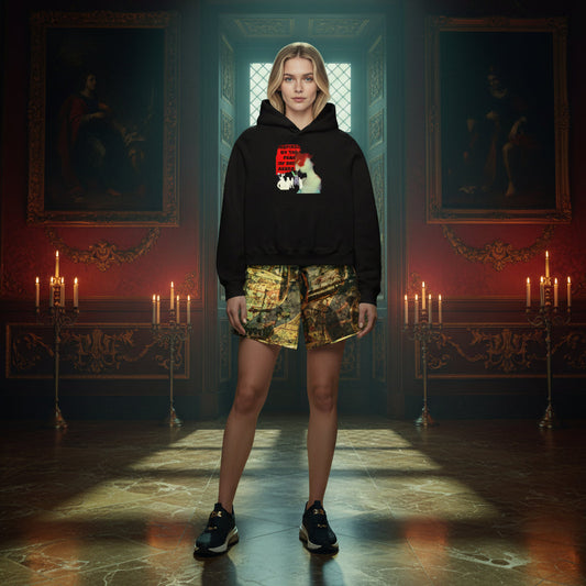 A woman stands in a grand, candle-lit room wearing a black graphic hoodie, camouflage print shorts, and black sneakers.