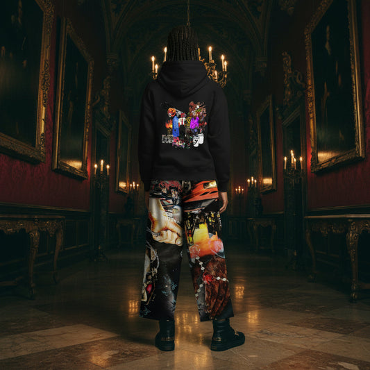 A person standing in a dark, ornate hallway wearing a black hoodie with a colorful graphic print on the back and highly patterned, multicolored cargo pants, paired with black boots.