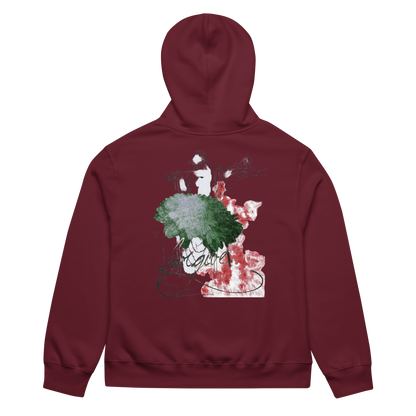 A maroon zip-up hoodie shown from the back, featuring a large graphic print on the back with green, red, and white paint-like splatters and stylized text.