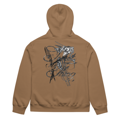 A tan hoodie shown from the back, featuring a large black and gray abstract graphic print across the upper back.